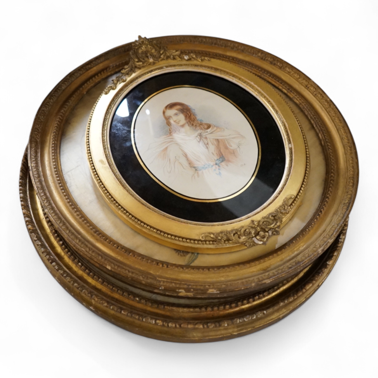 Two 18th century oval silkwork panels, one depicting flowers, monogrammed AM and dated 1787, together with a 19th century watercolour portrait of a lady, largest 42cm high